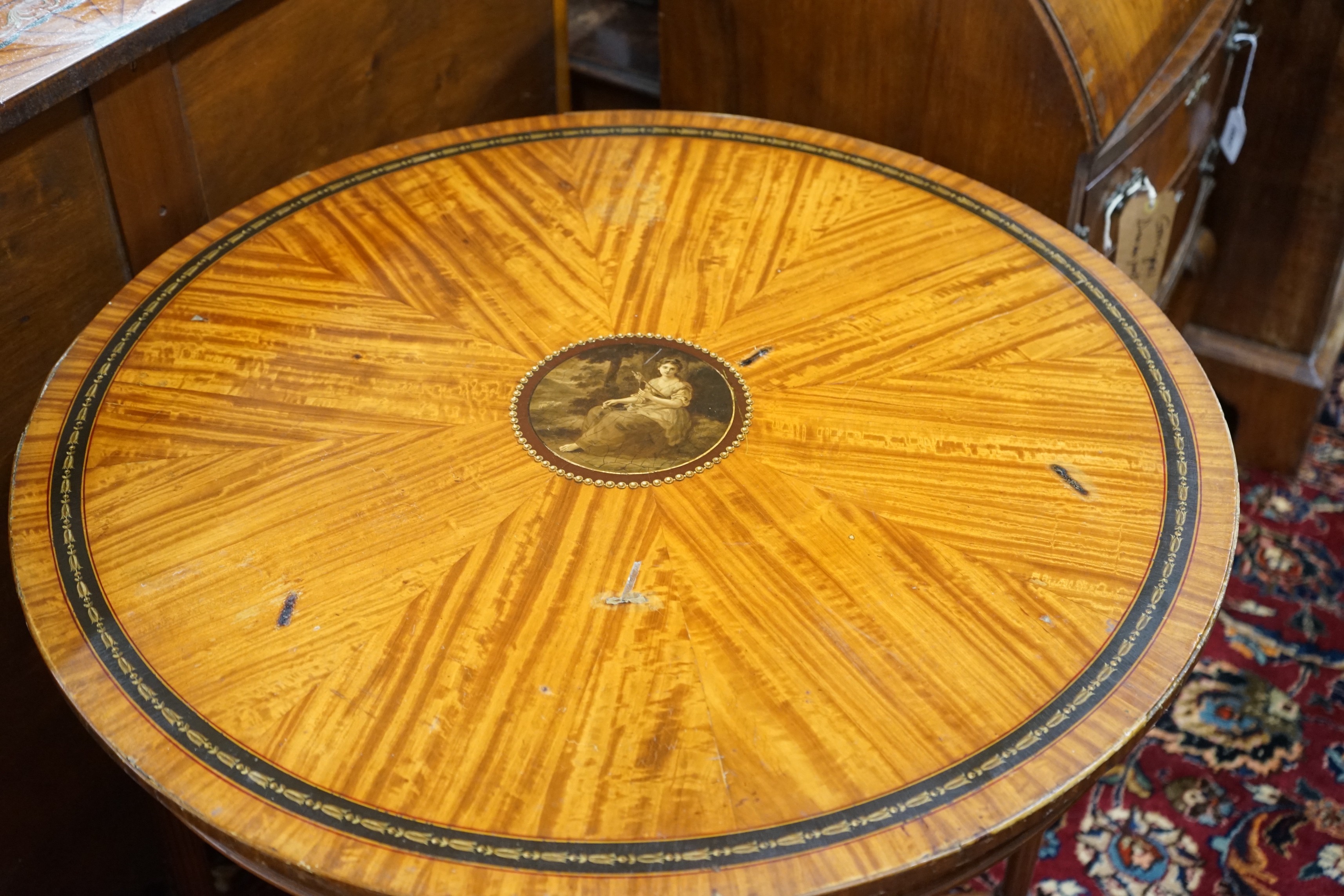 An Edwardian Sheraton revival circular painted satinwood centre table, diameter 76cm, height 77cm